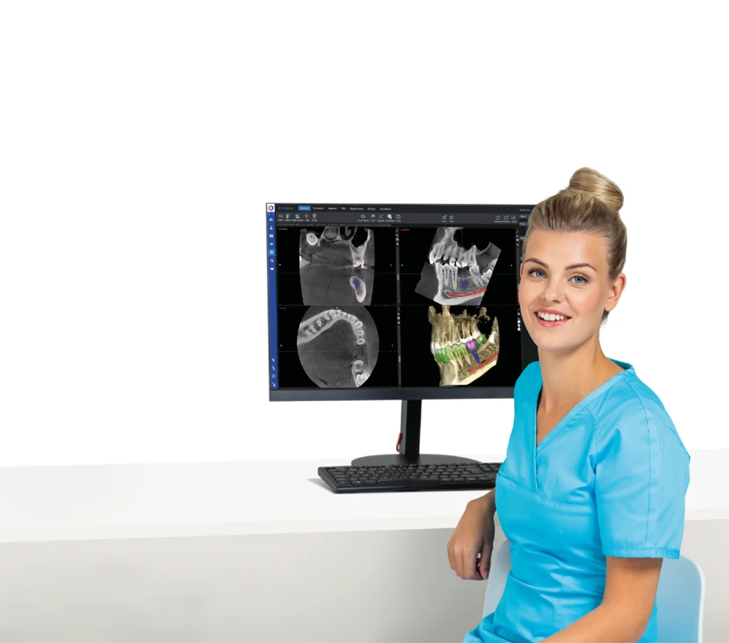 Technik przy monitorze z obrazami z tomografu Planmeca Viso G5